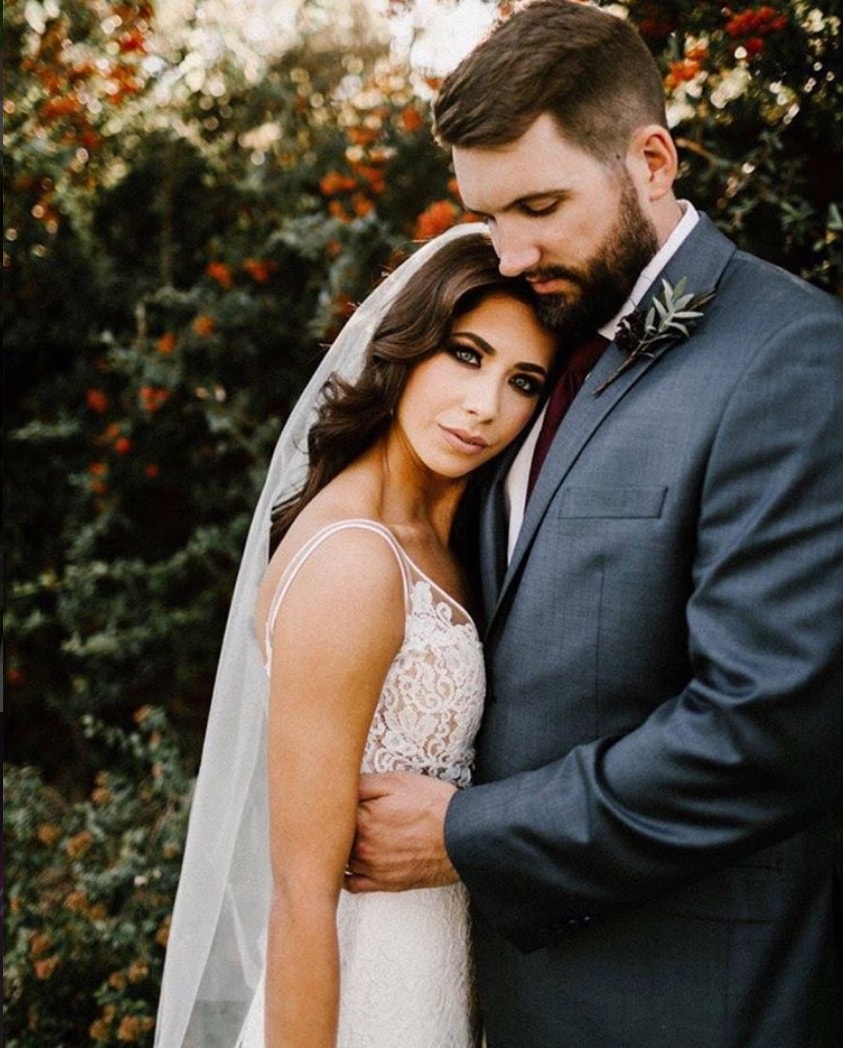 Сouple wearing a white gown and a gtray suit 2