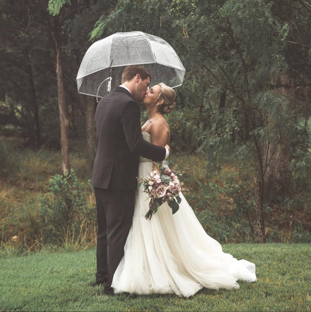 Сouple wearing a white gown and a black suit