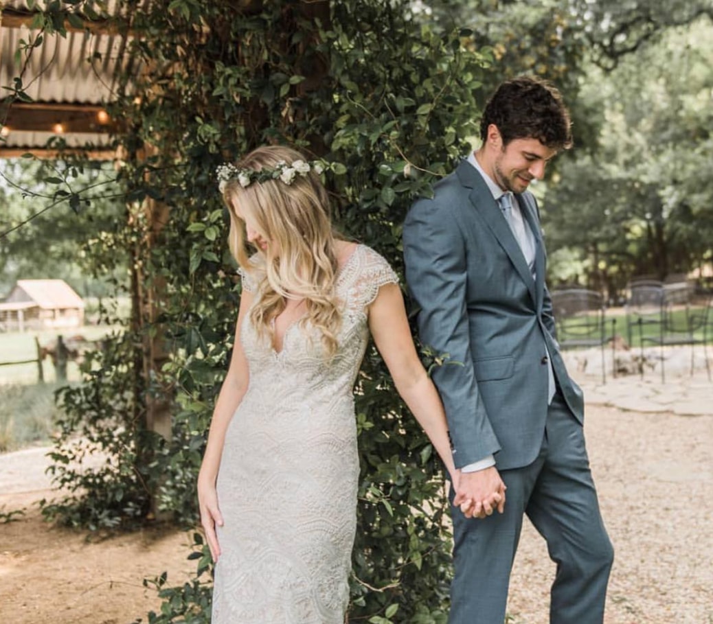 Сouple wearing a white gown and a gray suit